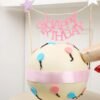 Bright and colorful birthday pinata cake with hidden candy inside and a hammer for smashing.