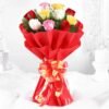 A radiant bouquet of mixed roses in fiery shades of red, orange, and yellow, wrapped in elegant paper.