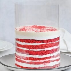 Red velvet pull-up cake with flowing cream and dramatic frosting reveal.