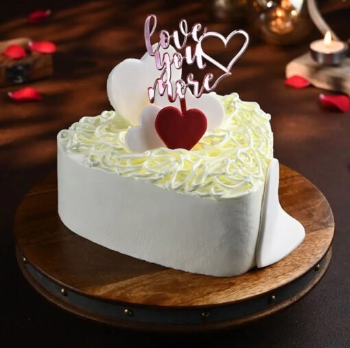 Heart-shaped creamy cake decorated with pearl-like accents, ideal for weddings, anniversaries, and romantic celebrations.
