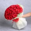 Whispering Crimson Charm – elegant red floral arrangement radiating gentle romance and sophisticated charm.