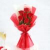 Elegant bouquet of crimson red roses wrapped beautifully, symbolizing passionate love and romantic desire.