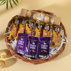 Wicker basket filled with assorted branded chocolate bars and artisanal truffles, wrapped in cellophane with a satin bow.