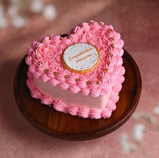 Heart-shaped cake with "Congratulations" message, perfect for celebrating success and achievements.
