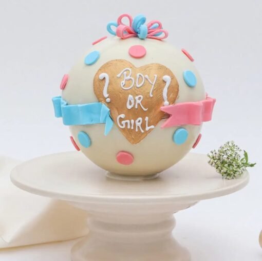 Gender reveal pinata cake with “Is It A Boy Or Girl?” message and surprise candy inside.