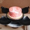 Strawberry-themed smash cake with hidden sweet surprises inside.
