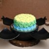 Chocolate smash bomb cake labeled "Boom N’ Bliss" with surprise treats inside and a mini hammer.
