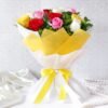 A luxurious bouquet of deep red velvet roses wrapped in elegant paper, symbolizing romantic love and passion.