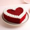 Heart-shaped creamy red velvet cake with smooth cream cheese frosting.