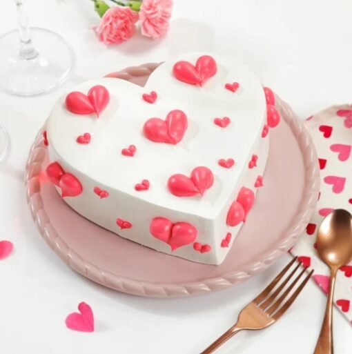 Romantic red hearts cake with heart decorations and rich cream frosting.