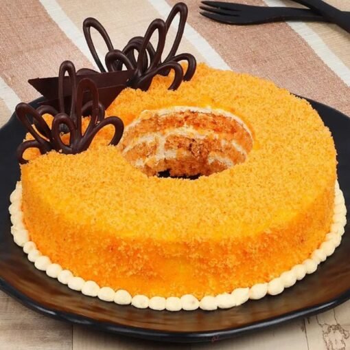 Donut-shaped orange-flavored cake with vibrant glaze and decorative toppings.