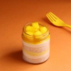 Dreamy Mango Jar Cake with mango mousse and sponge layers in a transparent dessert jar.