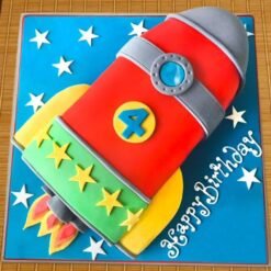 Happy Birthday Rocket Cake — rocket-shaped cake with stars and planets, ideal for a space-themed birthday party.