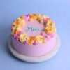 Maa’s Bliss Cake — elegant cake with delicate floral frosting, soft pastel colors, and a “Maa” topper perfect for Mother’s Day celebrations.