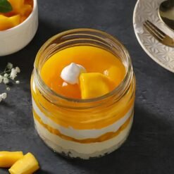 Mango Cream Rush Jar Cake Duo with creamy layers and fresh mango chunks in glass jars.