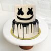 DJ Marshmello-themed cake with signature helmet design and music-inspired decoration.