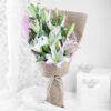Pinkish Serene Lilies Bouquet — elegant pastel pink lilies arranged with greenery, radiating calm, grace, and delicate beauty.
