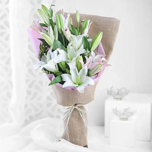 Pinkish Serene Lilies Bouquet — elegant pastel pink lilies arranged with greenery, radiating calm, grace, and delicate beauty.