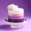 Purple Love For Mom Cake — stunning cake with purple floral decor, elegant piping, and a heartfelt “Mom” topper for Mother’s Day.