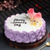 Purple Glow Women’s Day Cake with pink hues and floral decorations, perfect for celebrating the strength and beauty of women.