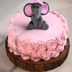 Cute baby elephant cake with rose decorations for baby shower or first birthday