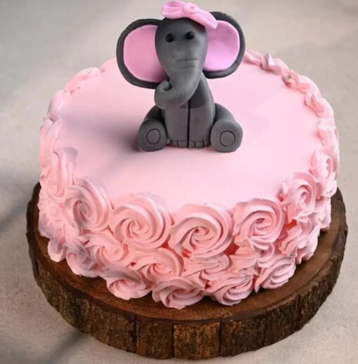 Cute baby elephant cake with rose decorations for baby shower or first birthday