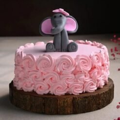 Cute baby elephant cake with rose decorations for baby shower or first birthday