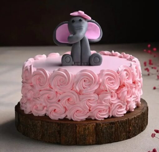 Cute baby elephant cake with rose decorations for baby shower or first birthday