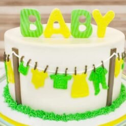 Fun ‘N’ All Baby Shower Cake decorated with pastel colors, baby toppers, and fondant accents.