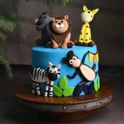 Happy Animals Jungle Cake with fondant jungle animals and green foliage decorations.