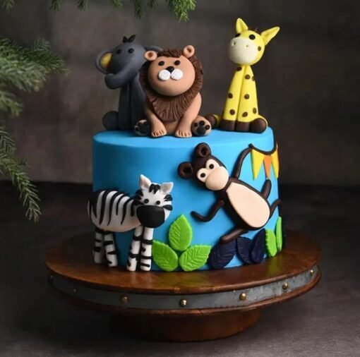 Happy Animals Jungle Cake with fondant jungle animals and green foliage decorations.