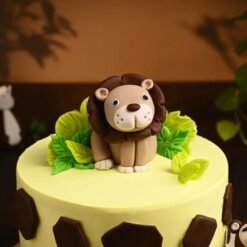 Jungle-themed lion king cake for kids with fondant lion topper