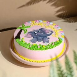 Pink baby elephant-themed cake with fondant decorations for baby girl.