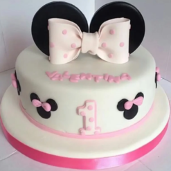 Pink Minnie Mouse birthday cake with bow and ears for girls