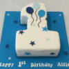 Pastel-colored first birthday cake with baby theme and cute decorations