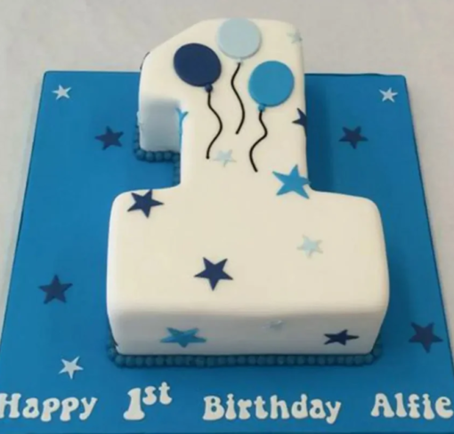 Pastel-colored first birthday cake with baby theme and cute decorations