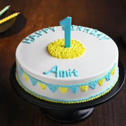 Adorable first birthday cake with number one topper and cute decorations