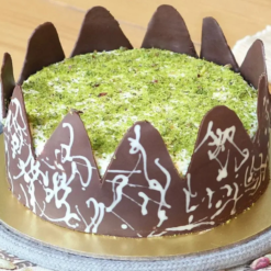 Rich chocolate cake topped with pistachio drizzle and crunchy nuts