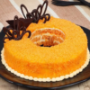 Donut-shaped orange cake with citrus glaze and zest
