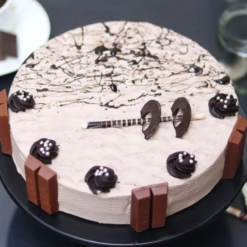 Rich chocolate truffle cake topped with KitKat bars and choco drizzle