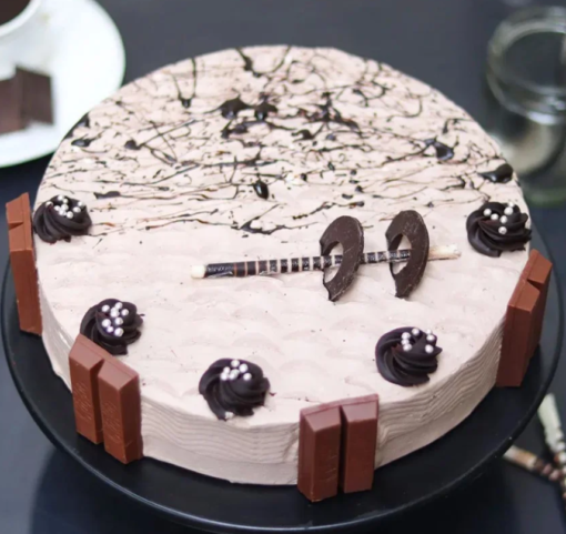 Rich chocolate truffle cake topped with KitKat bars and choco drizzle