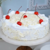 White forest cake with whipped cream, cherries, and white chocolate