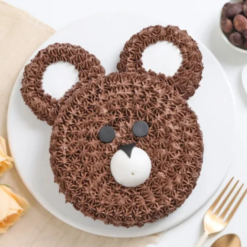Cute teddy bear-themed cake with pastel frosting for kids