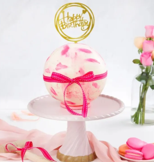 Round crystal-like pinata cake with hidden sweets inside