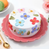 Floral-themed pastel cake with garden-inspired decorations